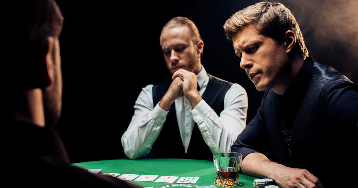 A dealer and two men playing poker
